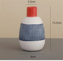 White ceramic polka dot vase with colorful graffiti lines living room by Decorbites