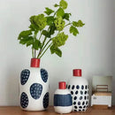 White ceramic polka dot vase with colorful graffiti lines living room by Decorbites