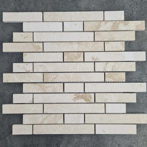 Shell Stone Limestone Strip Liner on 12" x 12" Mesh Mosaic Tile SKU-HSSSSLNBMOSH under sunlight