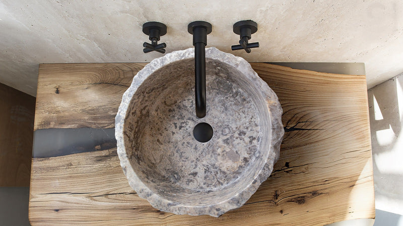 silver travertine rustic stone vessel sink polished interior hand chiseled exterior SKU NTRVS13 Size (D)16" (H)6" installed in the bathroom